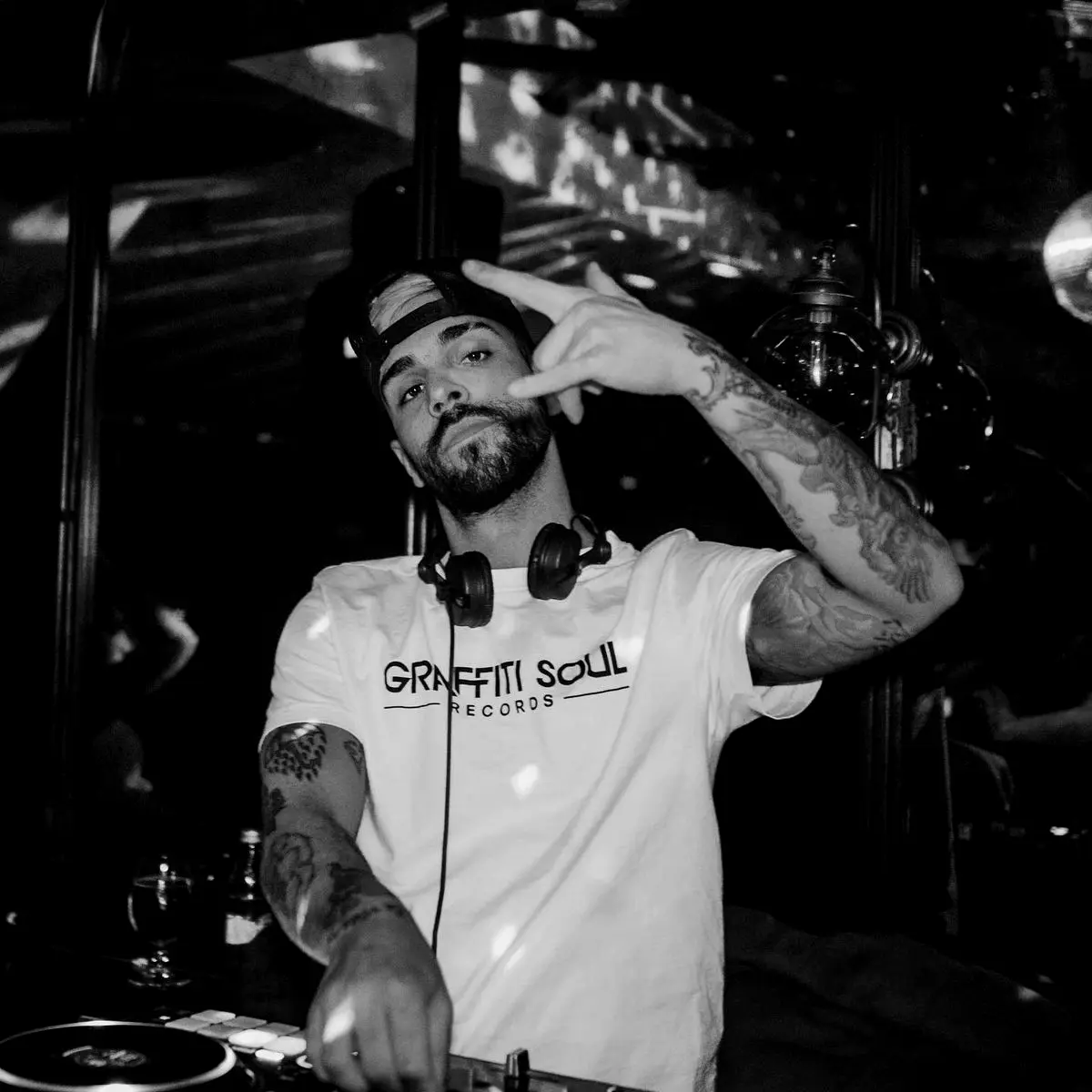 Tattooed DJ wearing a Graffiti Soul Records shirt